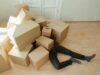 Man buried under a pile of boxes