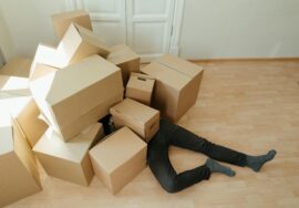 Man buried under a pile of boxes