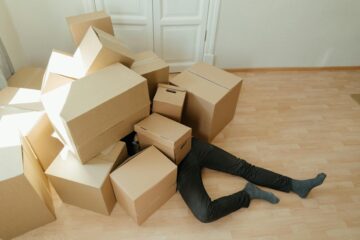 Man buried under a pile of boxes