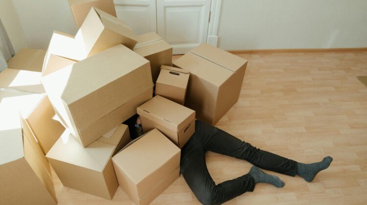 Man buried under a pile of boxes